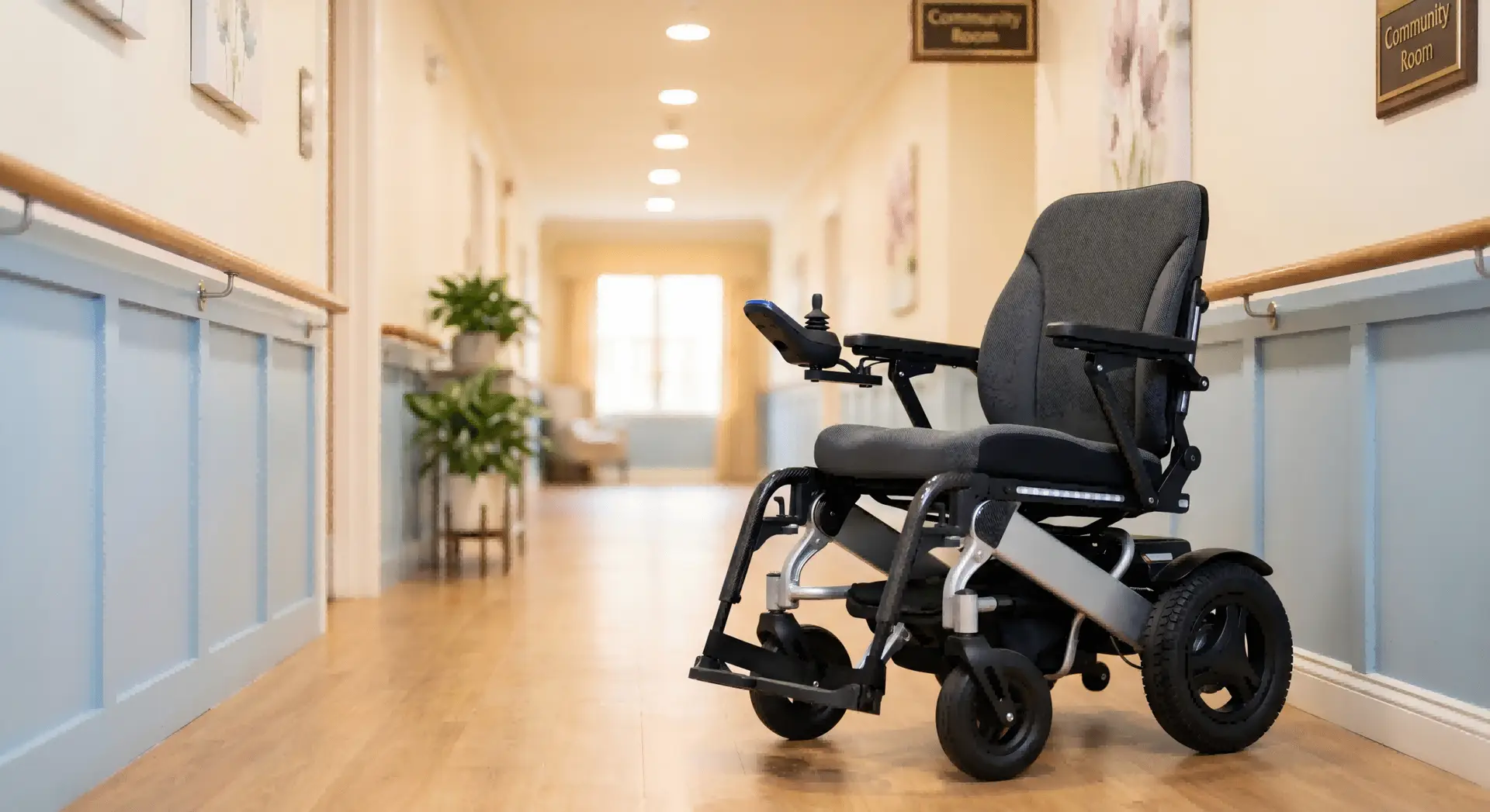 A modern electric wheelchair in a clean, bright nursing home hallway.